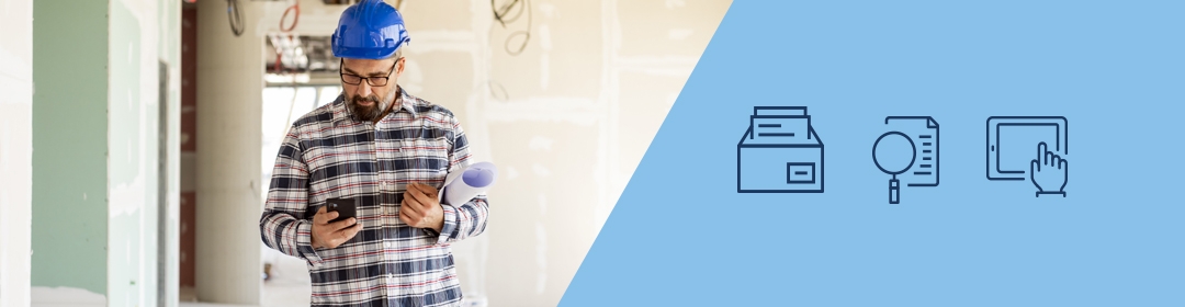 Image of a male employer working on a construction site while looking at his mobile phone. Icons of a letter, smart phone and tray are also on the image.