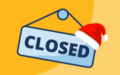 Sign that reads Closed and has a Santa hat hanging off it