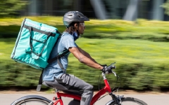 Image of delivery driver riding a bike